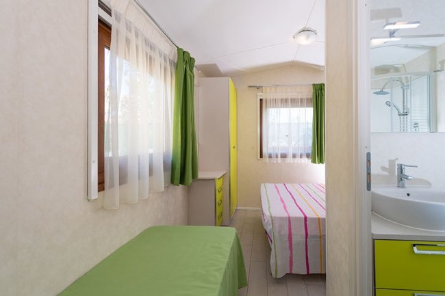 Camera luminosa con letto matrimoniale e singolo.